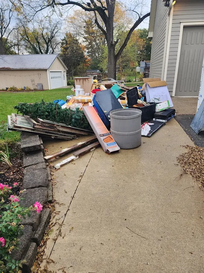 Dumpster being loaded with debris for Estate Cleanout Dumpster Rental in Travelers Rest